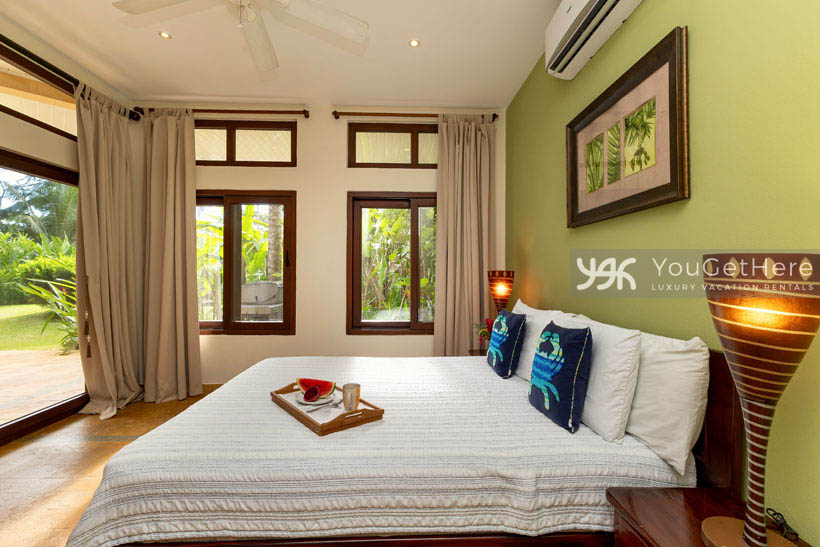 Lovely first floor guest bedroom with King size bed and slider door to pool deck.