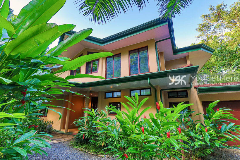 Caballitos del Mar Norte Entryway through beautiful landscaping tropical flowers.