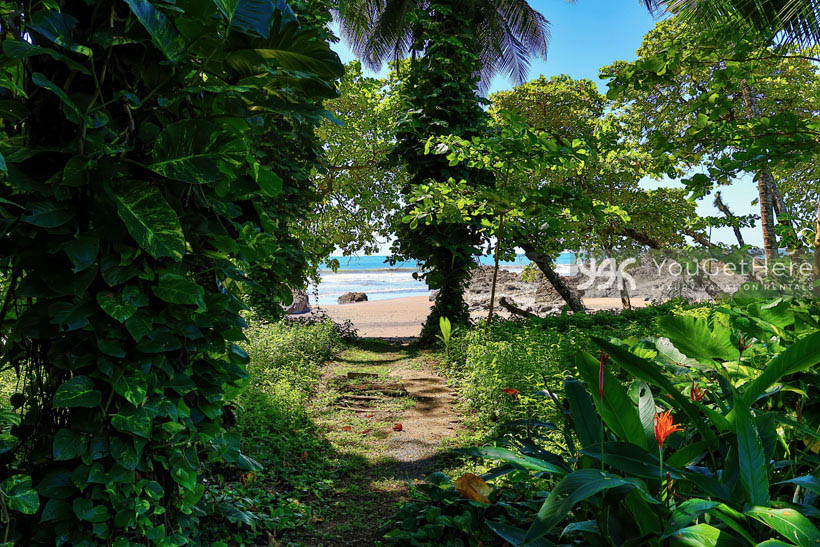 Pathway from Caballitos del Mar Complex to quiet sandy beach in Dominical Costa Rica.