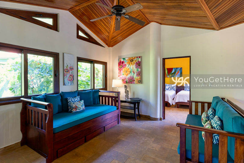 Second floor lounge area with sofa trundle bed and overhead ceiling fan at Caballitos del Mar Complex in Costa Rica.