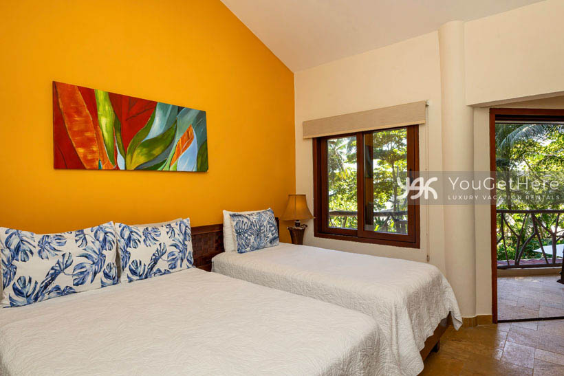 Caballitos del Mar Norte vacation villa guest bedroom with slider and balcony.