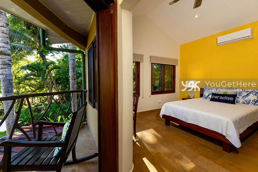 Caballitos del Mar Norte guest bedroom with slider opening to balcony beach and jungle views.