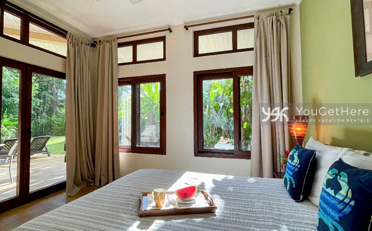 Guest bedroom at Caballitos del Mar Central with lovely tropical decor.