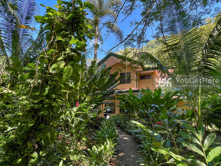 Landscaped path through the green trees and out to the beach at Caballitos del Mar Complex.