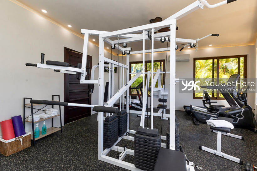 Jade House Costa Rica exercise room stocked with full weight machine, cardio equipment and yoga mats.
