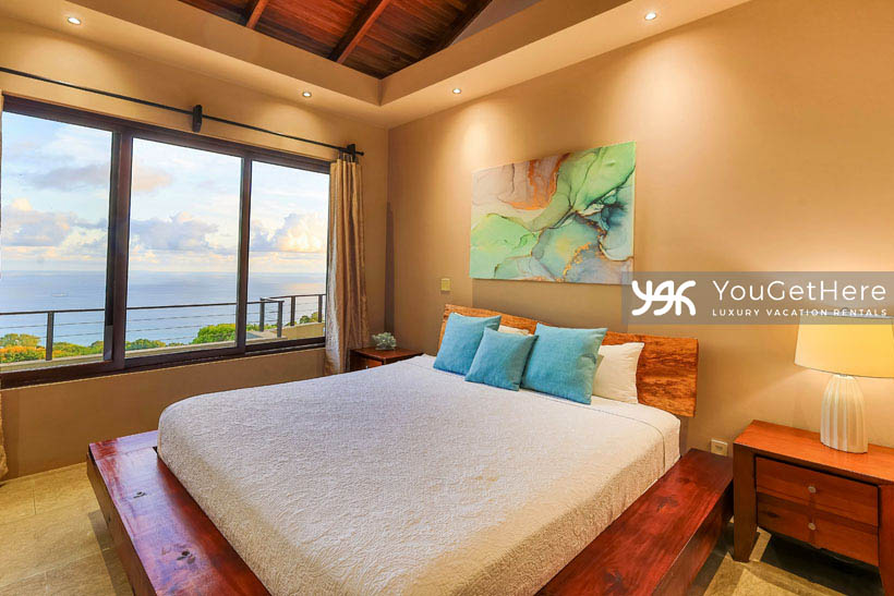 Jade house Costa Rica relaxing and comfortable guest suite with soft lighting and King bed overlooking ocean.