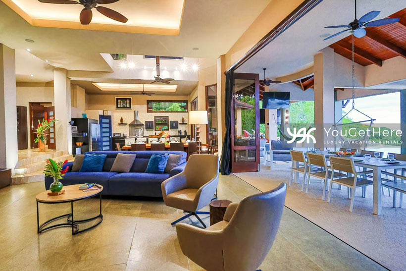 Jade House Costa Rica indoor outdoor living with huge sliding door to link outdoor dining area to indoor family room.