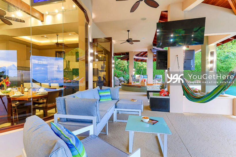Jade House Costa Rica outdoor lounge seating with hammocks, overhead fans and mounted television.