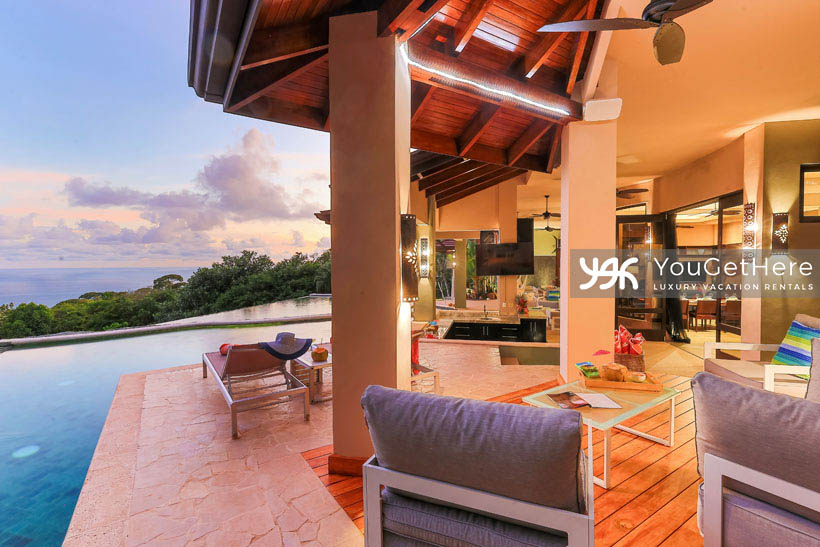 Jade House Costa Rica outdoor couch and chairs next to swim up bar and patio.