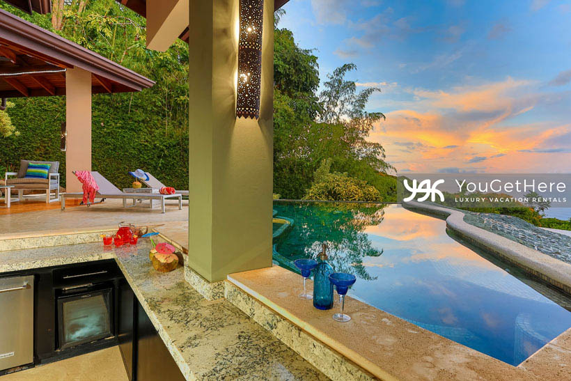 Jade House Costa Rica outdoor kitchen bar and swim-up bar featuring wine fridge and lovely stone bartop.