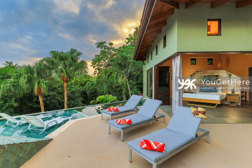 Jade house Costa Rica primary suite patio with lounge chairs on deck and submerged in primary's personal pool.
