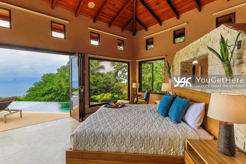 Jade house Costa Rica incredible primary suite with endless ocean views from bedroom and walk-out to lounge chairs and pool.