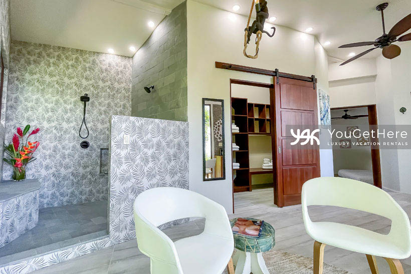 Jade House Costa Rica stunning guest room with large walk-in closet and massive dual shower heads, with stone seat in walk-in shower and overhead lighting and ceiling fans throughout.