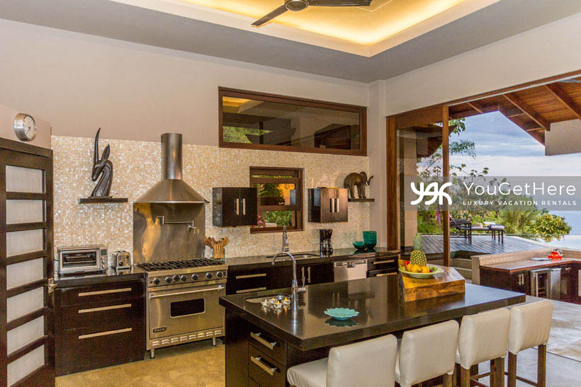 Chef's kitchen with lots of counter and pantry space, island counter with second sink, huge oven with ample gas burners.