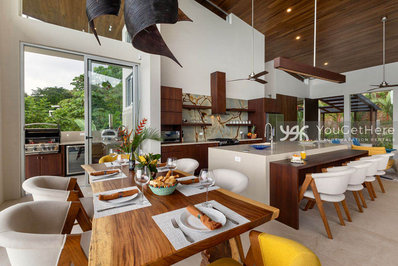 Open style floor plan unites beautifully decorated kitchen, dining and bar with built-in outdoor BBQ and wine fridge on balcony.